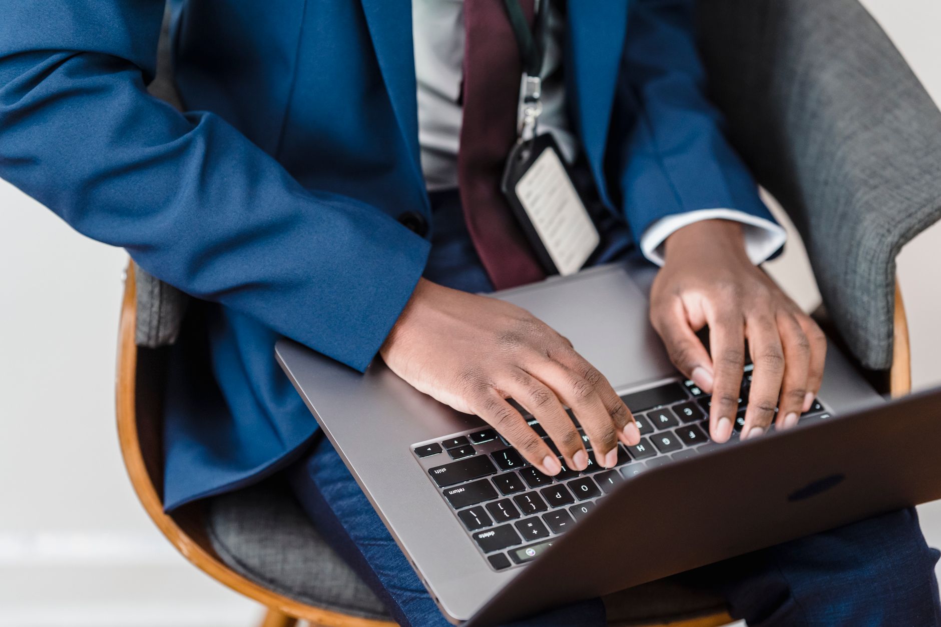 Person typing a sales outreach email on a laptop with ChatGPT visible