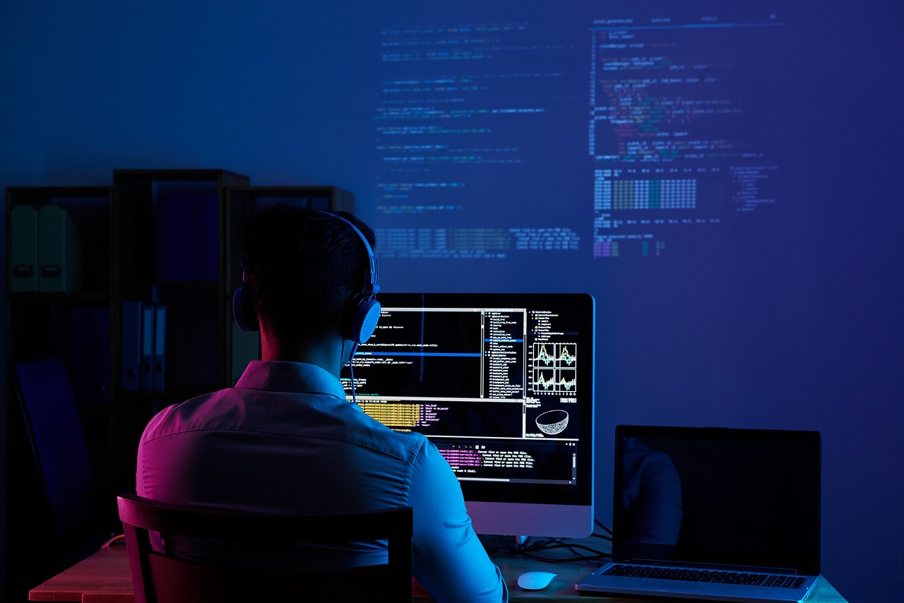 Software developer writing code on laptop screen showing AI editor interface