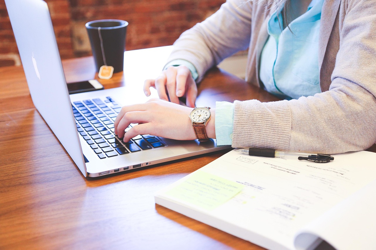 Person typing into a ChatGPT coding assistant on laptop