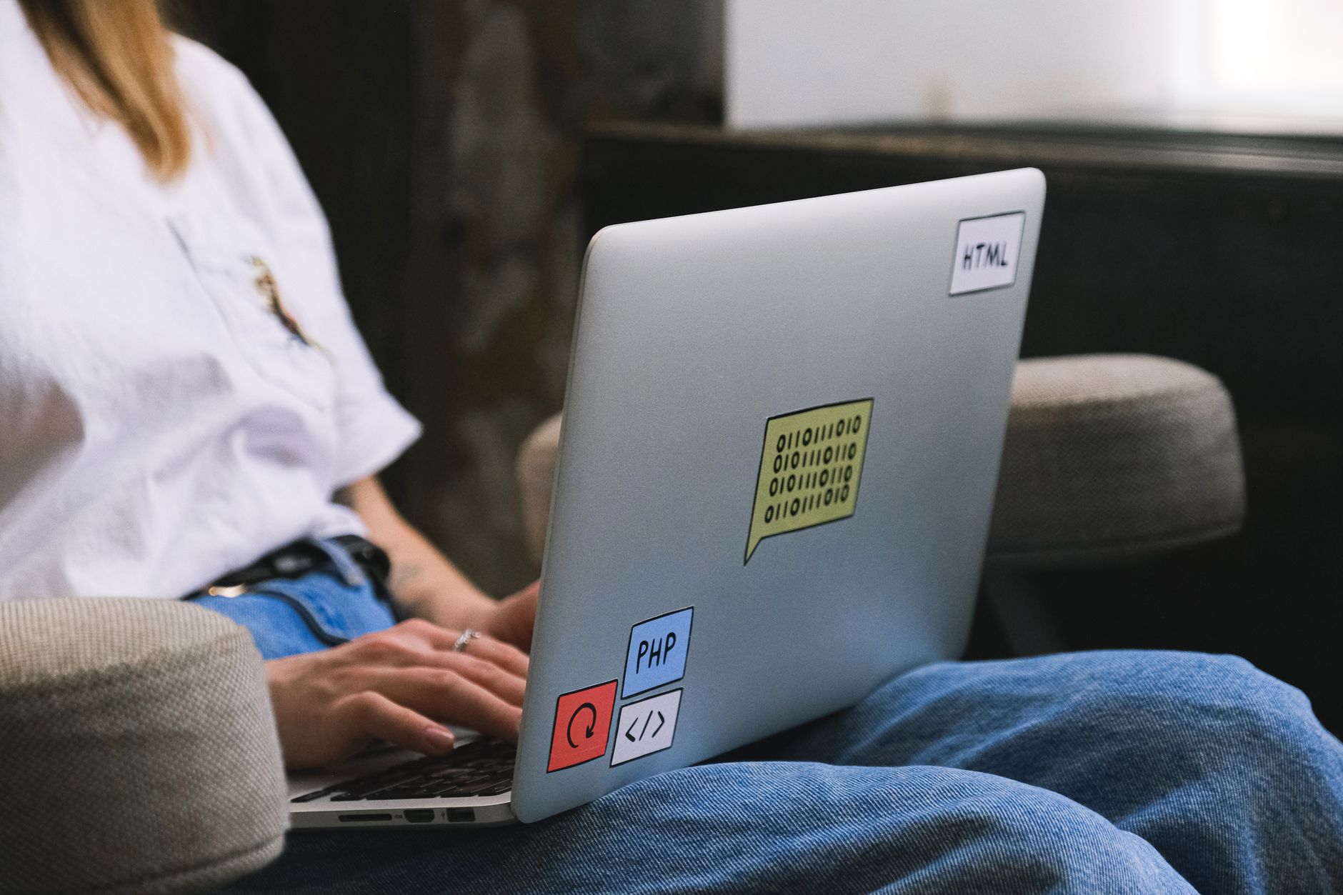 A developer configuring an AI agent workflow on a laptop with code and diagrams visible.
