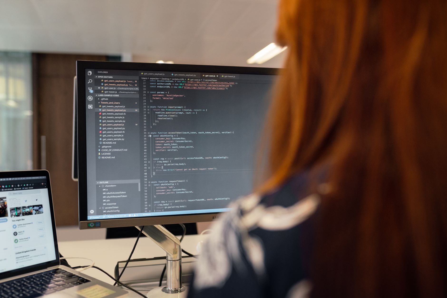 Developer using AI code editor with autocomplete suggestions on monitor