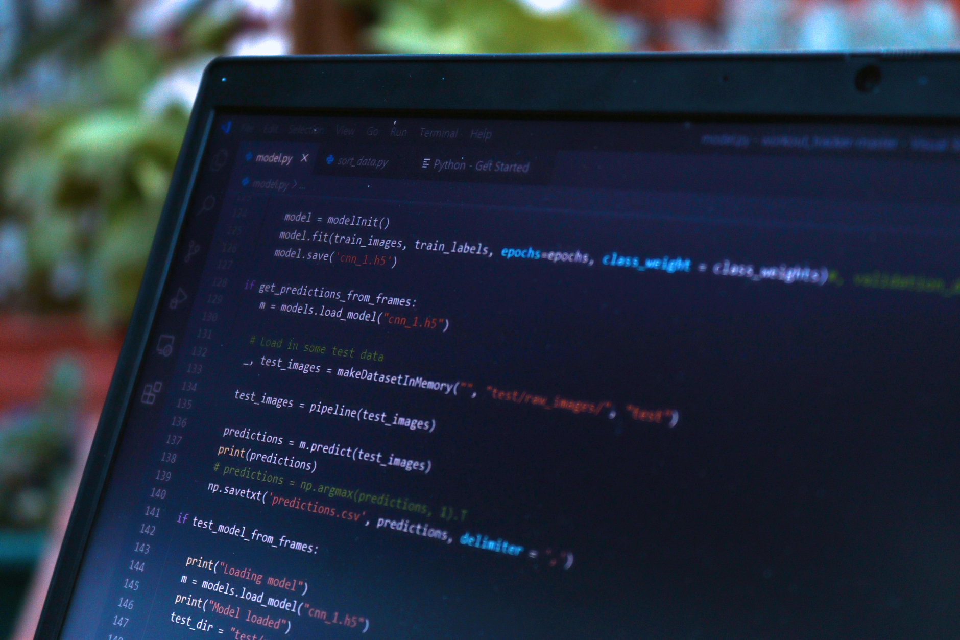 Person typing Python code on laptop with AI agent diagram on screen
